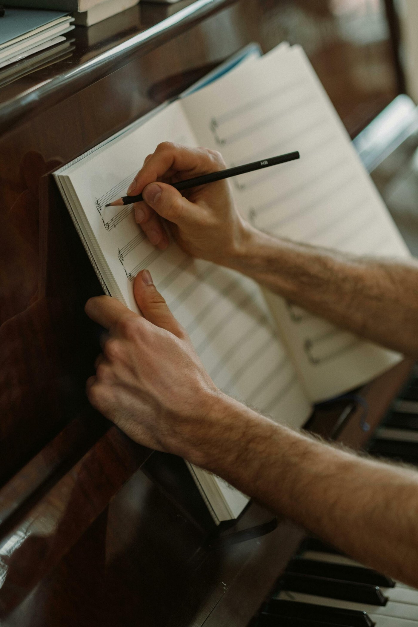 Sheet music open on an upright piano during a rehearsal, warm low light